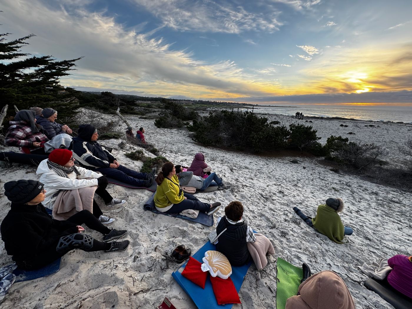 Group watching sunset on the coast