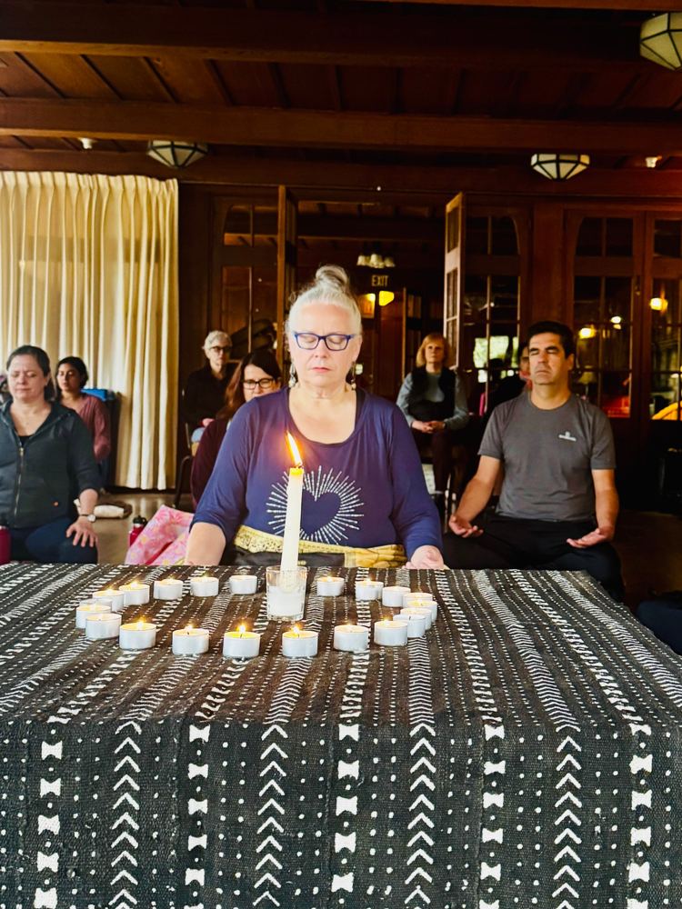 Candlelit group meditation indoors